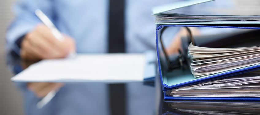 person writing with business books